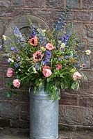 A milk churn filled with flowers - arrangement in June
