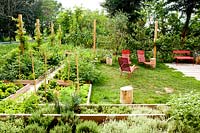 Vegetable garden of raised beds with seating area, part of a restaurant