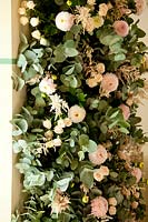 Vertical column of Rosa - Rose and Dahlia - Pompon - flowers with Eucalyptus leaves