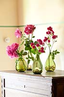 Mixed roses in green glass vases