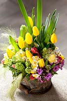 Tulips, hyacinths, daffodils displayed in a metal container