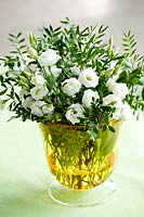 White lisianthus in a small glass vase