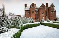 Box hedges and pyramids covered in snow at Beckley Park, Oxfordshire, UK.
