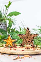 Scented decorations made from metal cookie cutters filled with orange peel and cinnamon sticks