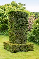 Clipped topiary Yew column - Taxus baccata - in the Silent Garden at Scampston Hall Walled Garden, North Yorkshire, UK. 