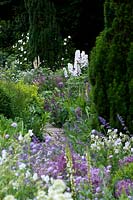 Cottage garden with borders of flowering perennials. 