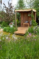 Garden shelter by the pond in 'Garden Inspiration: The Dew Pond' at RHS Malvern Spring Festival 2018
