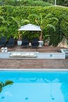 Swimming pool and seating area, in Italian villa. Borgio, Liguria, Italy