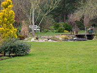 View across lawn to a rockery and water feature
