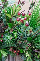 Close up detail of Hypericum, Hebe, Pine and Fir in wreath