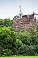 View across lawn and trees to historic royal St James's Palace 