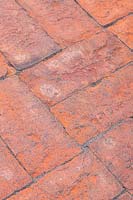 Freshly laid red brick pavers with joins set with polymer sand