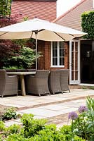 Patio with dining furniture and parasol