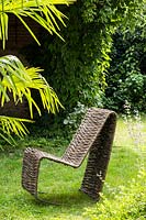 Handcrafted woven Salix - Willow - rocking chair on lawn 