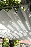 Overhead folding shading on a roof garden 