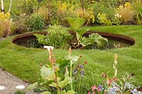 Mimosa Design: Grace and Dignity Garden, pond in lawn with Gunnera 