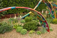 Painted hoops in the What If In Support of Rees Foundation Garden, set in gravel with planting 