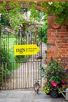National Gardens Scheme garden open for charity sign on gate - with cat