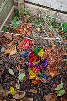Putting Quality Street sweet wrappers on the compost heap
