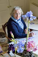 Ann Fraser in her studio painting irises. 