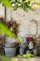 The antiques atelier by Gian Matteo Malchiodi with various galvanised watering cans and buckets against the wall