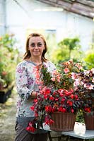 Marta Stegani with potted Begonia in container.