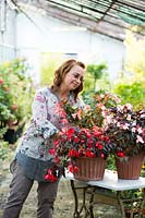 Marta Stegani tending to potted Begonias in her garden. 