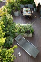 Looking down on roof terrace, showing decking, and the layout of the planters to divide the dining and relaxing areas 