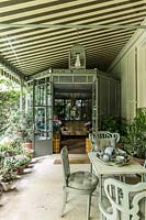 Two shady verandas connect the outdoor area dominated with pots of purple flowers preferred by Pierre Berge