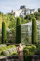 Mixed topiary on the terrace with figurative sculpture.  The garden focuses on perfumed evergreens - pitosfori, olive trees, oleanders and lonicera nitida.