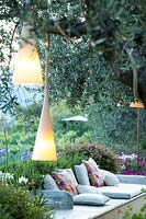 Hanging lights in an Olea europaea - Olive - tree near relaxing area 