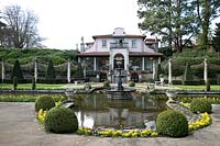 The villa overlooking the pond, fountain and topiary 