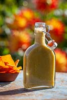 Garcia's green chilli sauce in a bottle with tortilla chips