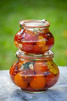 Drowned tomatoes in round jars