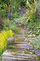 Wooden walkway with mixed border