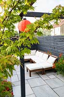 Modern Town Garden in Essex - sitting area with white sofa and Acer.