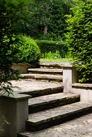 View of steps in formal garden. 