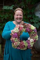 Woman holding finished Hydrangea wreath 