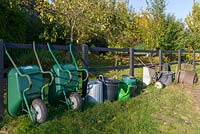Lined up gardening equipment, including wheelbarrows