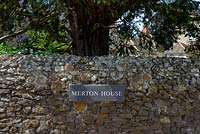 House sign on old stone wall