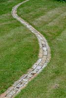 Winding brick path through a lawn