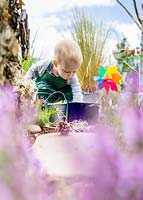 Young toddler playing in sensory garden