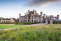 The shell of Lowther Castle with parterre in front, view from wildflower meadow 