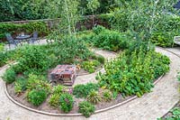Overview of suburban garden showing circular spiral pattern brick path