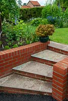 Newly constructed red brick and slab steps with turn and leading from tarmac drive to lawn - Open Gardens Day, Coddenham, Suffolk