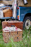 Picnic baskets and vintage luggage at the back of landrover