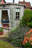 Summerhouse beside border of Lavender, Purple Sage and Alstroemeria aurea 'Indian Summer', also known as Peruvian Lilly - Open Gardens Day, Woolpit, Suffolk