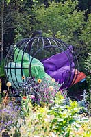 Seating cage with bean bags in corner of garden