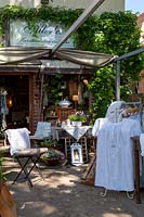 Store with vintage garden furniture and handicrafts outside in summer