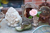 A collection of vintage objects on garden table 